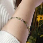 Polish designer green amber bracelet worn on wrist
