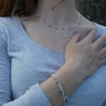 Crystal charm necklace worn layered on neckline everyday style