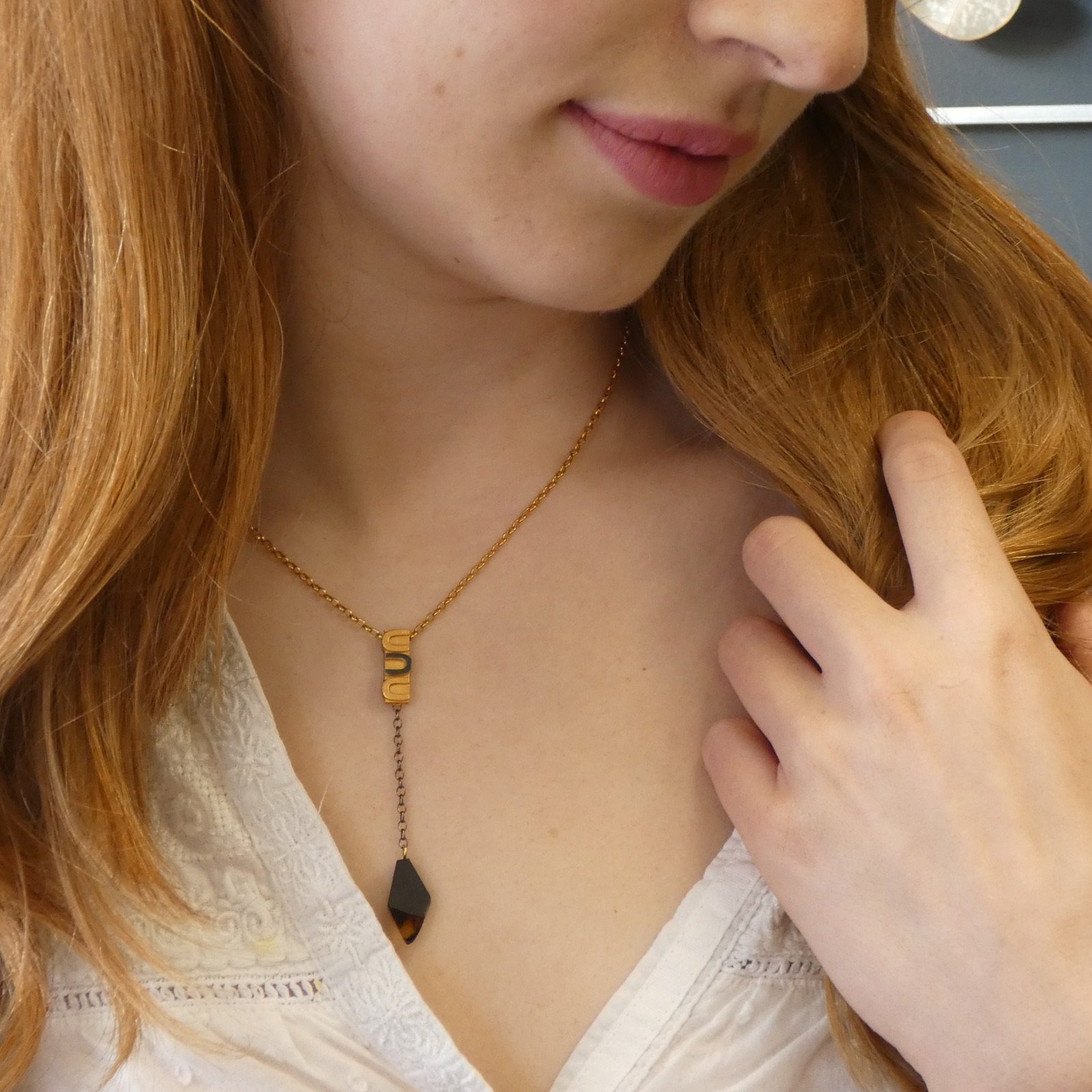tie style necklace silver gold two tone handmade jewellery durham uk moon jewellery Limited edition sterling silver Baltic amber necklace on neutral background