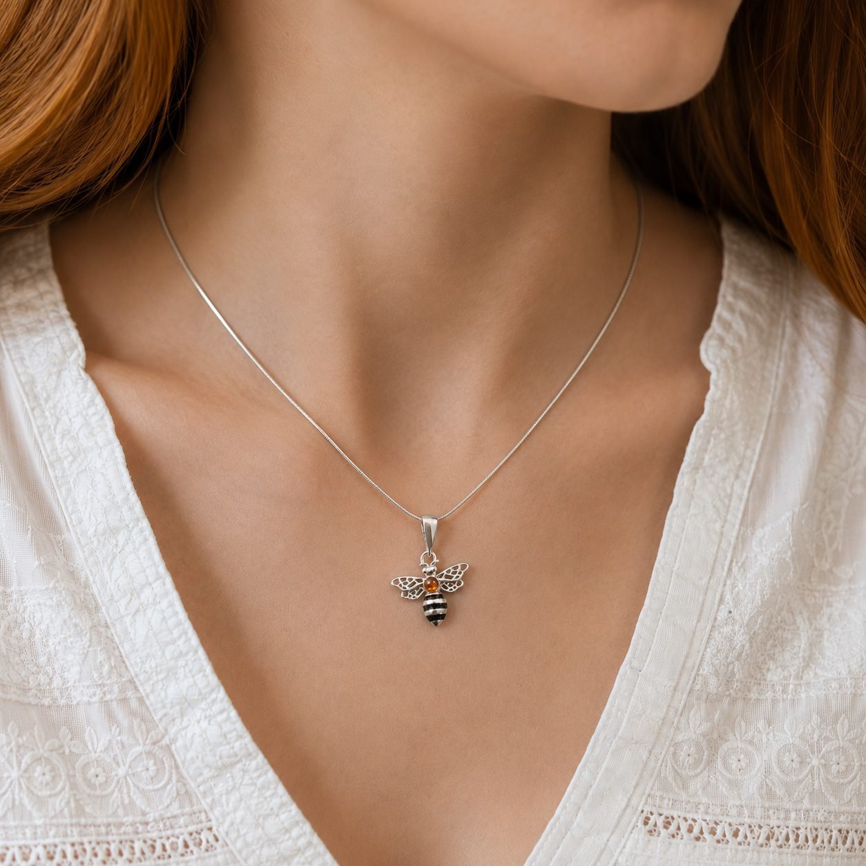 Baltic amber bumble bee pendant necklace worn on neckline nature inspired