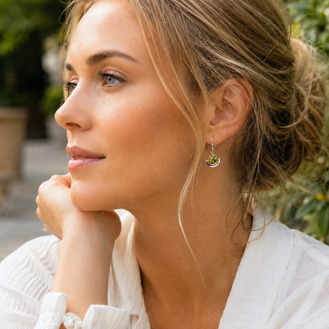 Contemporary green amber crescent drop earrings worn handcrafted Polish artist