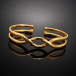 Infinity design in fluid 14ct gold plated sterling silver 925 cuff bracelet close up