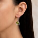 Deep green Baltic amber in sculptural polished sterling silver crescent drop earring