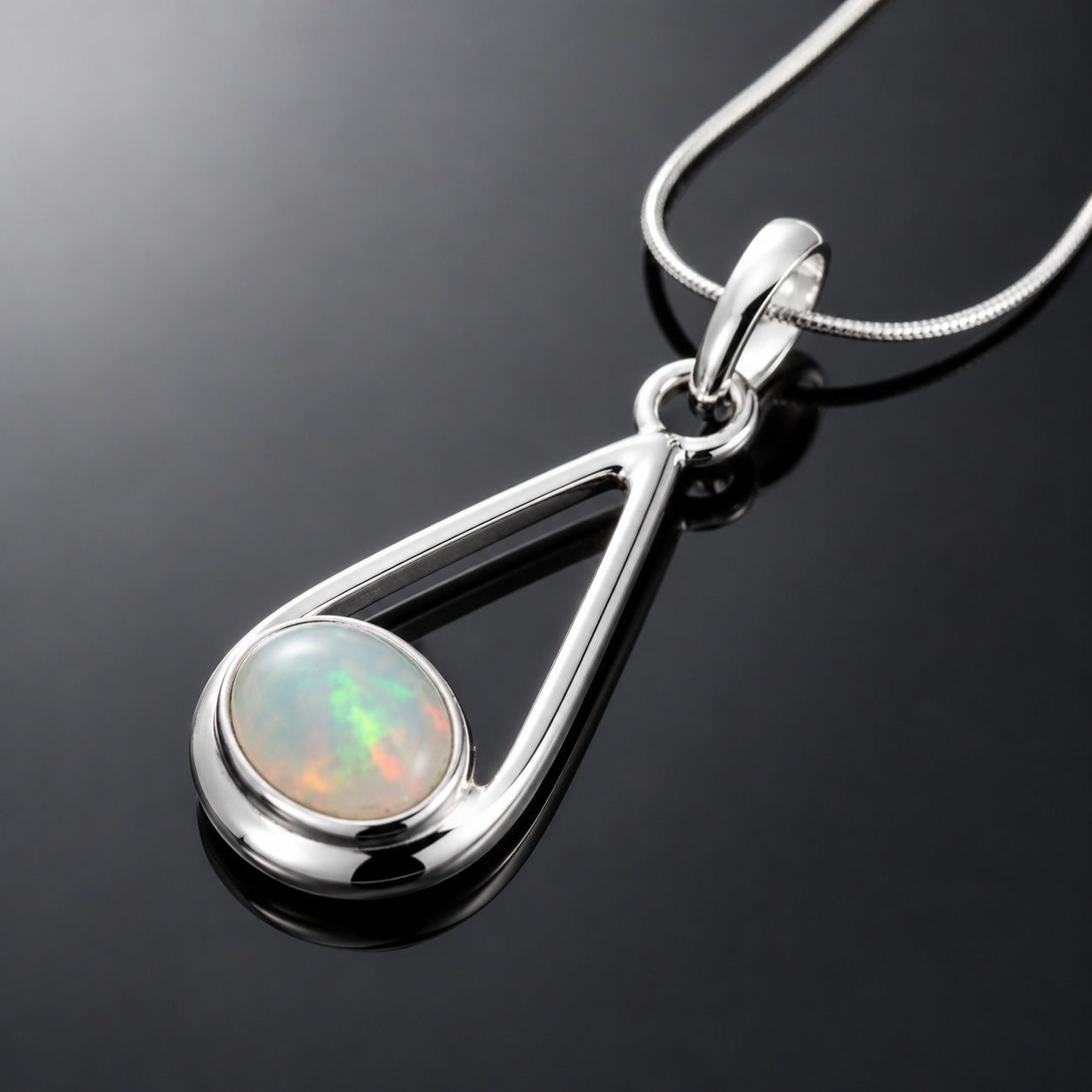 Natural Ethiopian opal cabochon play of colour green pink red blue in mirrored silver frame