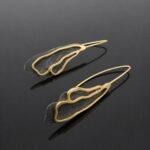 Ruthenised sterling silver deep black and brushed gold plated abstract curl earring close up