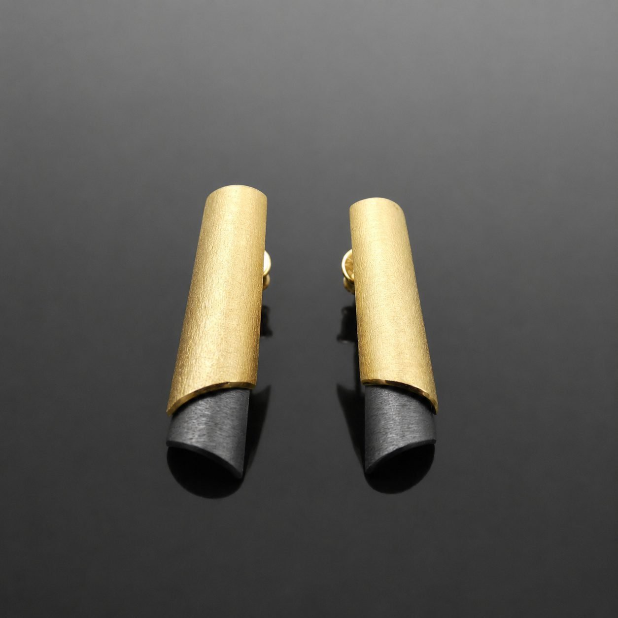 Ruthenised black sterling silver stud with brushed gold polished edges