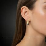 Contemporary black and gold stud earrings worn minimalist design Polish designer wearable art