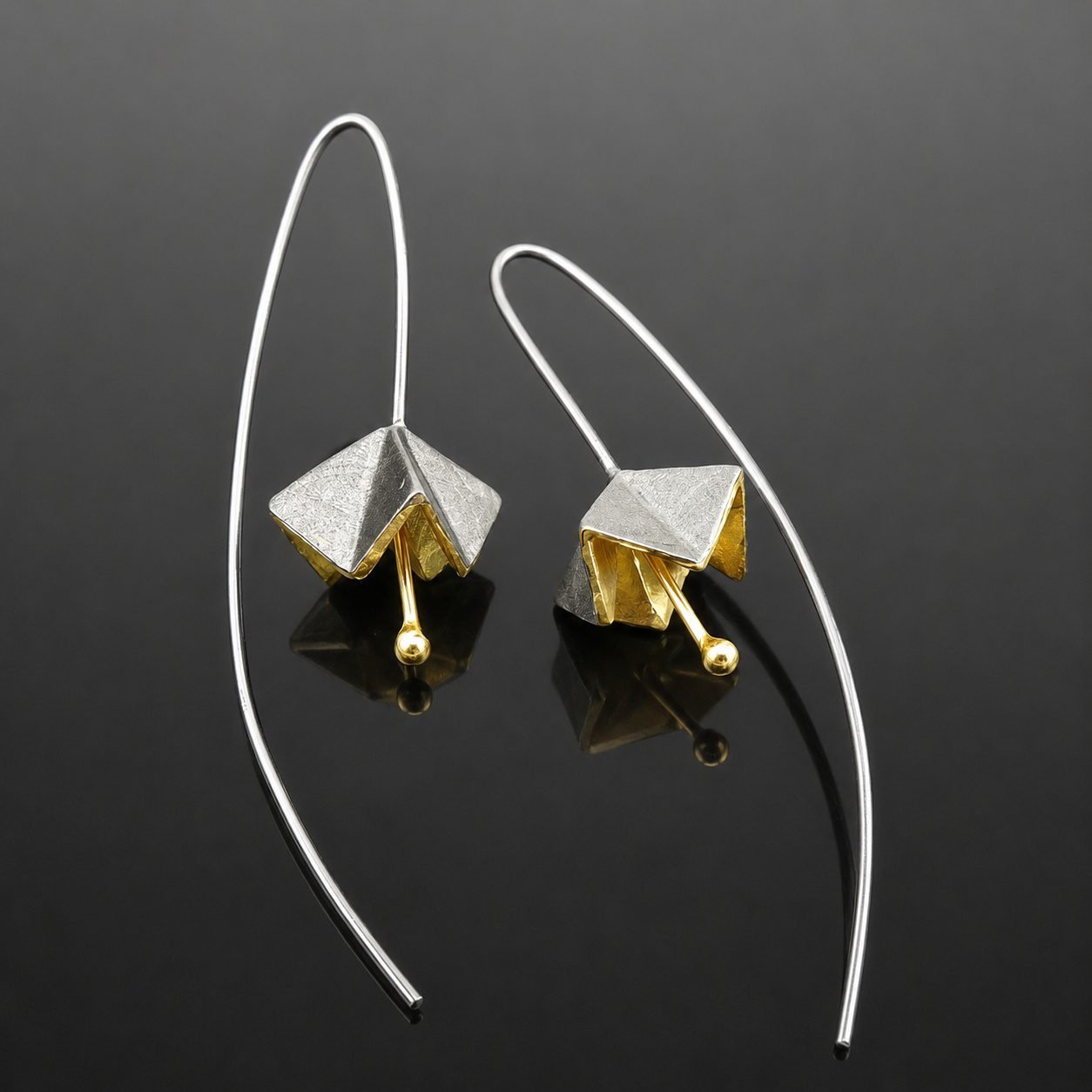 origami gold and black contemporary earrings handmade jewellery uk moon jewellery Sharp angled origami flower sterling silver gold plated front oxidised back close up