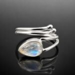 Glowing moonstone in wrap around mirrored sterling silver 925 adjustable ring close up